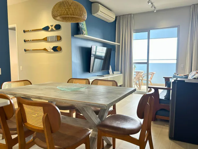 Mesa de jantar ao lado da janela com vista para o mar